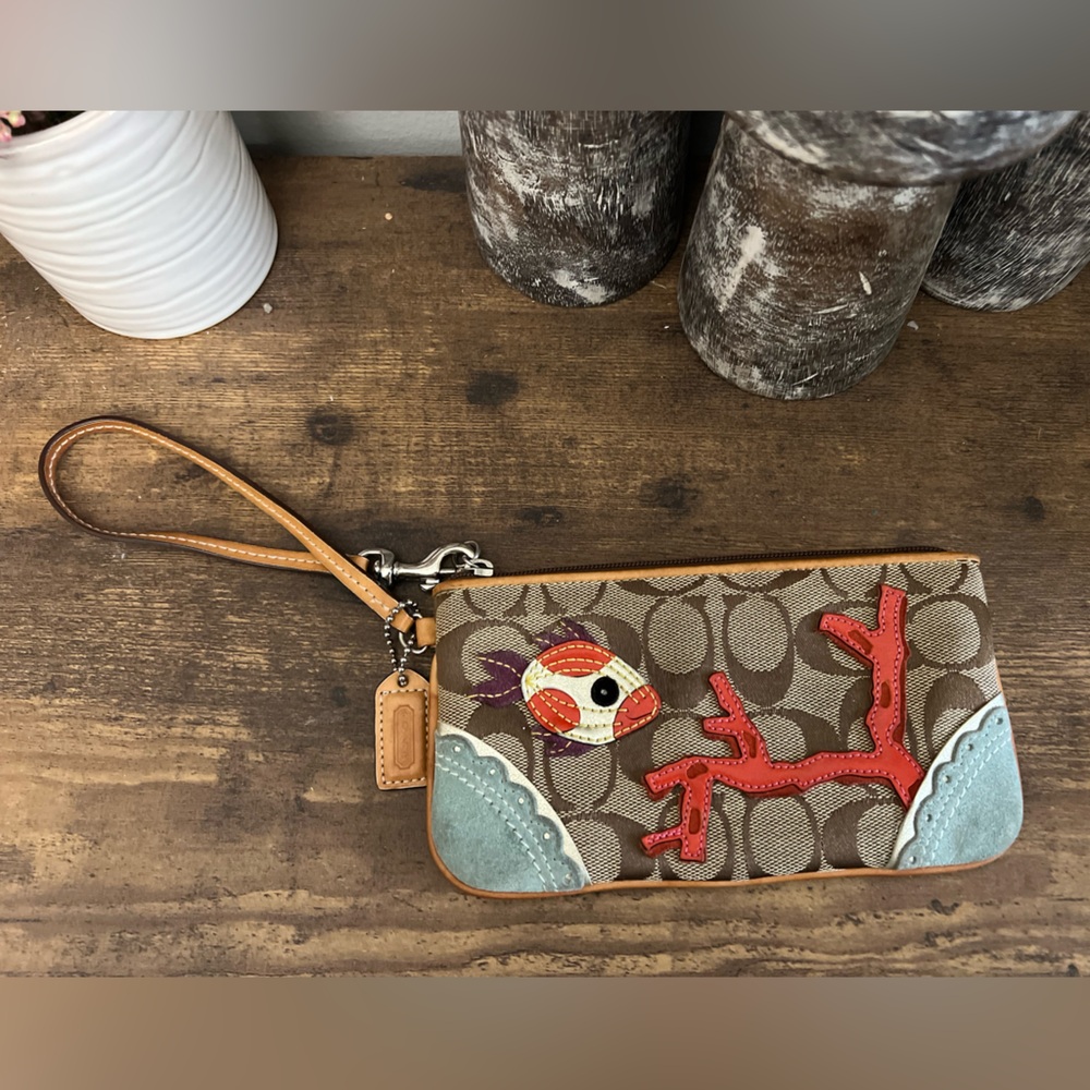 Coach signature C fish and coral wristlet